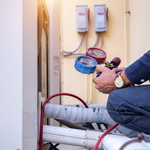 A Technician Services an HVAC System.