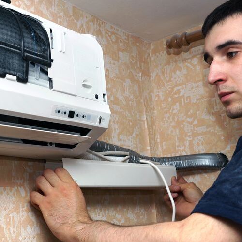 An HVAC Technician Checks a Mini Split System.