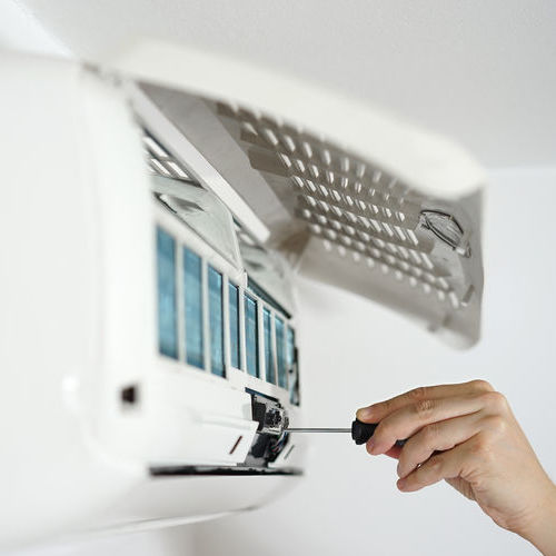 Technician Adjusting a Mini Split Air Handler