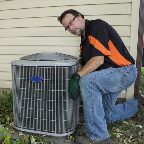 An HVAC Technician With an Air Conditioner