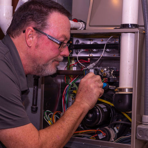 A Technician Tests a Gas Furnace.